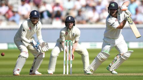 Ireland batter Paul Stirling hits out, watched by England wicketkeepre Jonny Bairstow