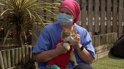 A woman holding a cat