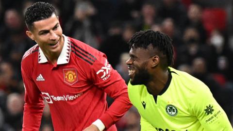 Francis Uzoho and Cristiano Ronaldo share a joke during Manchester United's game against Omonia Nicosia in the Europa League