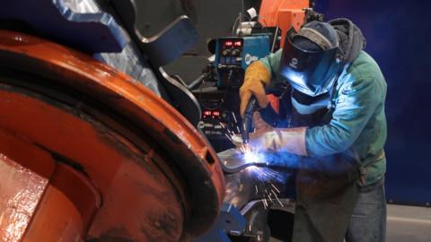 a worker makes a wheel assembly