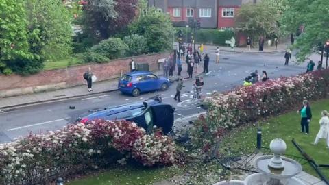 Crash scene showing car on its side