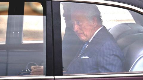 King Charles III and Queen Camilla arrive by car at Buckingham Palace in London ahead of their coronation ceremony on 6 May 2023