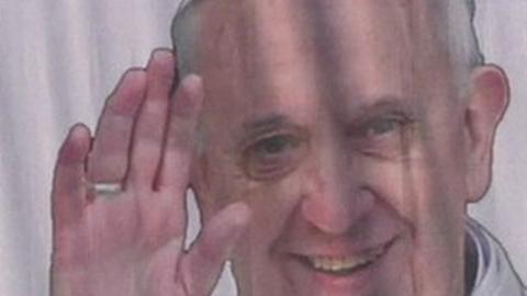 Pope Francis image on a banner