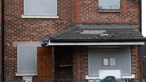 Image of property in St James Court, Grangetown which was subject to a closure order by magistrate showing rubbish and boarded up windows