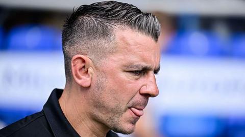 Matt Bloomfield looks on from the sidelines at a game