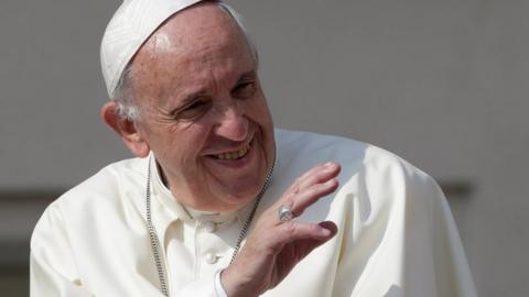 Pope Francis waves during his general audience in Saint Peter's square at the Vatican, on 14 June