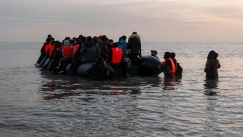 A migrant dinghy prepares to disembark from Gravelines, France