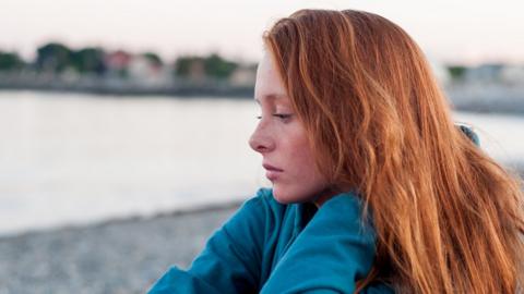 Young woman staring into space