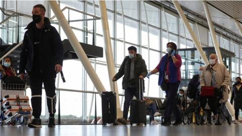 People walk inside Schiphol Airport