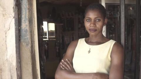 Women standing in doorway with her arms folded