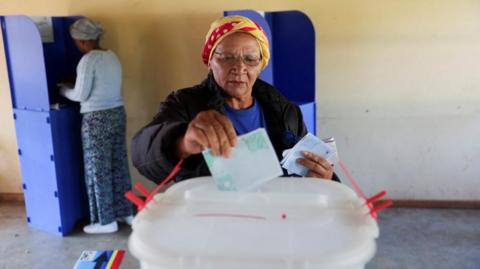 A voter casts her ballot at a polling station during the Eswatini's parliamentary elections in Mbabane, Eswatini,