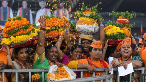 Female BJP supporters throw flowers