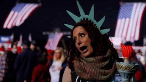 An audience member dressed as the Statue of Liberty arrives for a campaign rally with US President Donald Trump