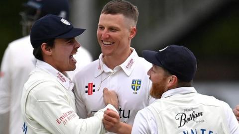 Durham celebrate a wicket for Brydon Carse