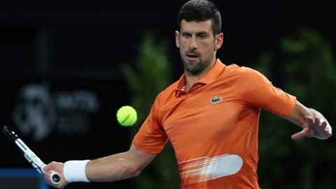 Novak Djokovic hits a forehand