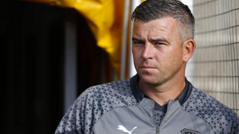 Plymouth Argyle manager Steven Schumacher looks on in the summer sunshine