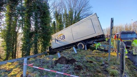 Firefighters working at the scene of a single vehicle RTC at Antrim's Dunsilly roundabout