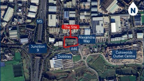The image is an aerial map view of a commercial and industrial area. The proposed Lidl site is highlighted in red. "Alexandra Way", "A46", and "Junction 9" on the M5 motorway are labelled in blue, showing major roads and access points.
Nearby landmarks: "Dobbies" and "Cotswolds Outlet Centre" are also labelled in blue.