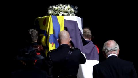 The Duke of Edinburgh's coffin, covered with His Royal Highness's Personal Standard is carried into St George's Chapel, Windsor Castle, Berkshire, followed by the Prince of Wales during the funeral of the Duke of Edinburgh.