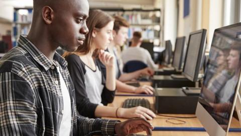 Students using computers (posed by models)