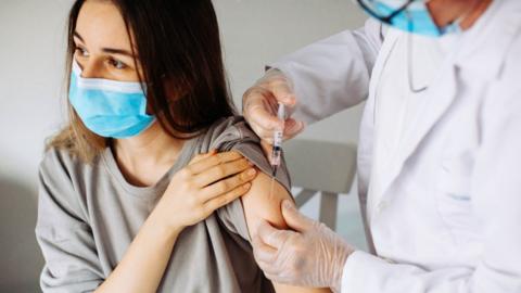 Young woman receiving vaccine