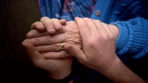 Generic picture of health carer holding hand of an elderly patient