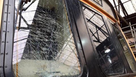 A smashed front window on a train