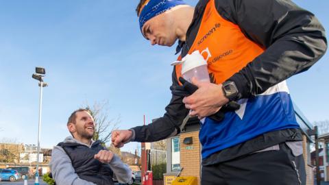 Kevin Sinfield fist-pumps Rob Burrow at Headingley after day five of his seven marathons challenge