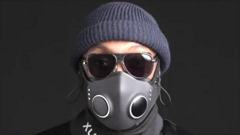 Artist will.i.am wears a blue beanie hat, sunglasses and the Xupermask - a smart facemask