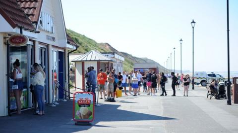 People stand on the promenade