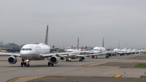 A line of United Airlines airplanes wait to take off at Newark Liberty International Airport on July 13, 2021