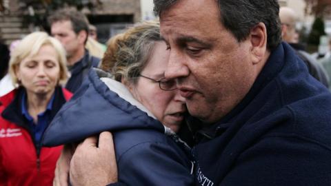 New Jersey Gov. Chris Christie (R) tries to comfort Alice Cimillo whose home was damaged by Superstorm Sandy November 1, 2012 in Moonachie, New Jersey