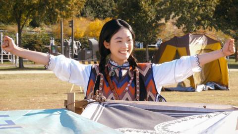 Strong Girl Nam-soon sitting under a home-made yurt in a park in Seoul