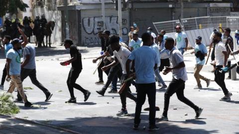Opponents of the Eritrean regime move in a street during a protest against a pro-regime event followed by clashes with Israeli police, in Tel Aviv, Israel, 2 September 2023.