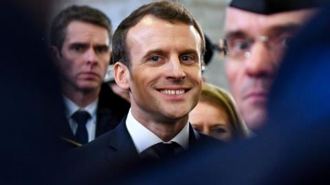 French President Emmanuel Macron smiles during his visit in the French northern city of Calais on 16 January