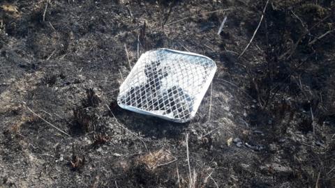 Disposable barbecue on burnt land