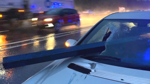 Car with a post sticking through its front window