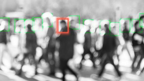 A blurred man is singled out of a crowd by a tracking square in this photo illustration