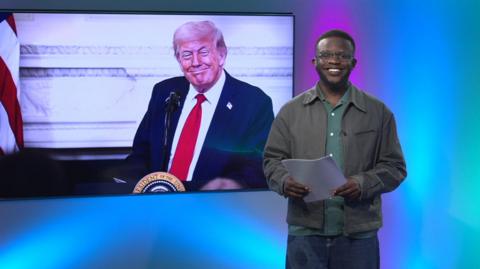 De-Graft in the studio with Donald Trump in the screen