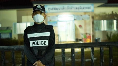 A police officer stands guard