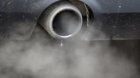 An exhaust emits fumes as a car is driven