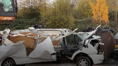 Image of a dumped wrecked car