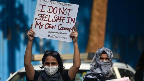 Activists hold placards during a protest to condemn the alleged gang-rape and murder of a 19-year-old woman in Bool Garhi village of Uttar Pradesh state, in Mumbai on October 6, 2020.