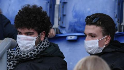 Fans wear masks at the Roma game