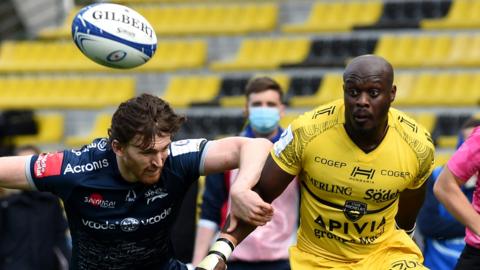 Raymond Rhule of La Rochelle breaks past Simon Hammersley of Sale Sharks