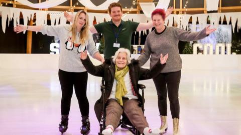 Eileen on the ice with staff from Alexandra House care home