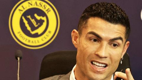 Cristiano Ronaldo, in front of an Al-Nassr FC logo