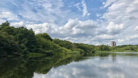 Sunny spells over a lake in Birmingham. Picture by BBC Weather Watcher Dammo