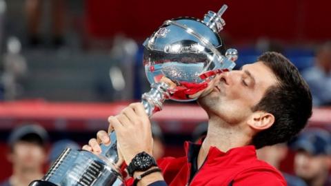 Novak Djokovic kisses the Japan Open trophy