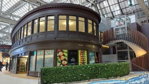 An empty unit sits above M&S Simply Food in Glasgow Central Station. 